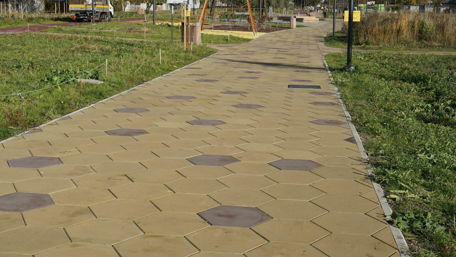 Paver pathway running through a green lawn