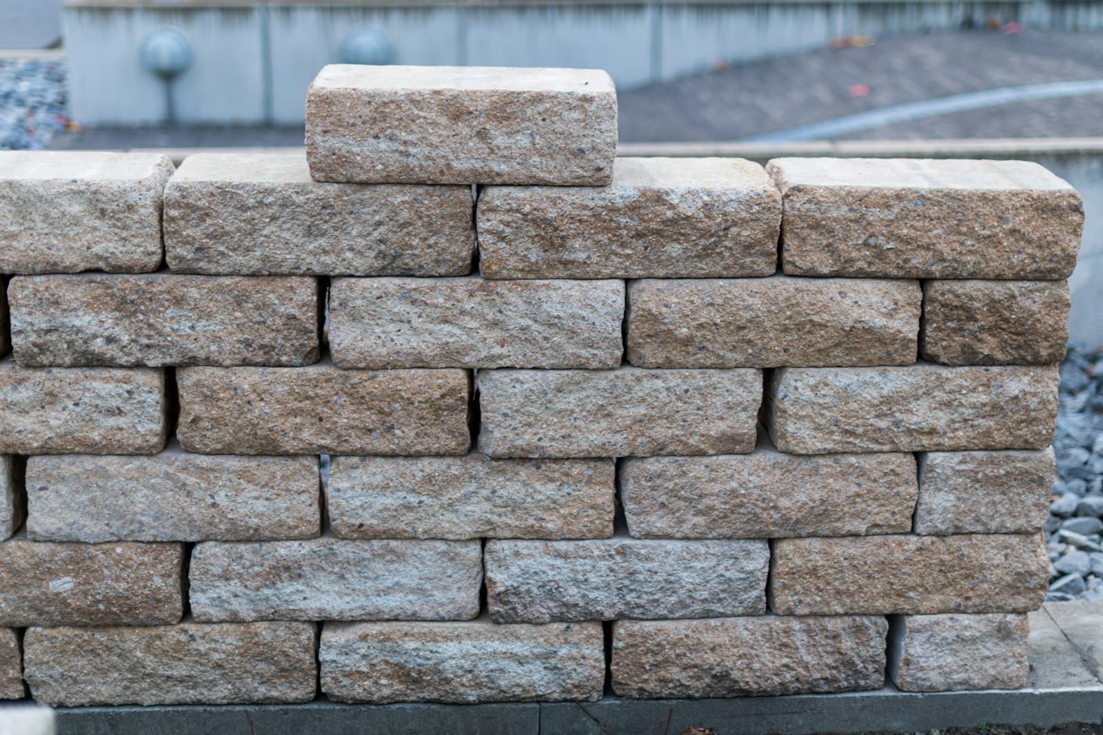 Wall built from rough tan stone blocks